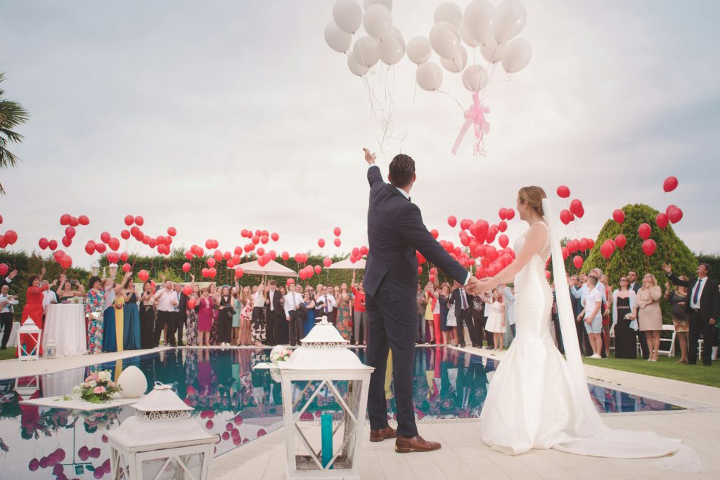 Bride and groom under an archway of flowers