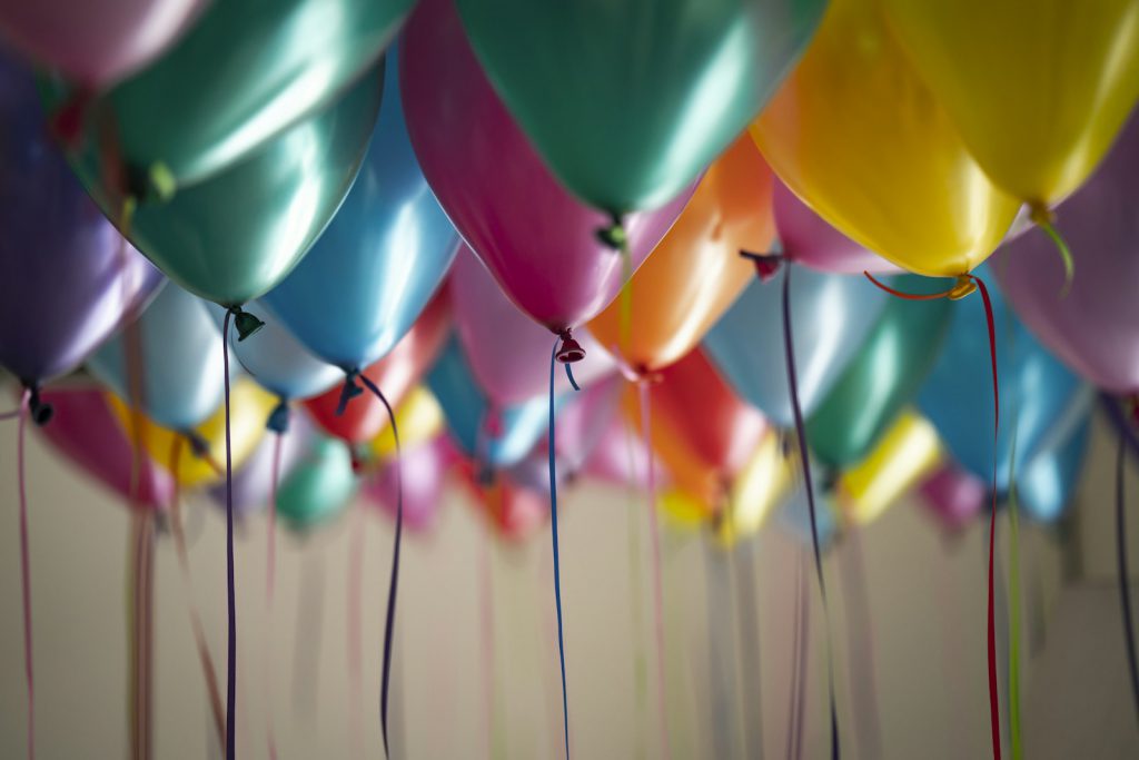 Pastel balloon arch in a bright room
